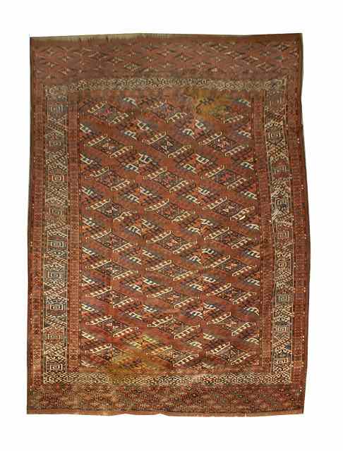 Appraisal: A TURKOMAN YOMUT MAIN CARPET decorated rows of stylised interlocking