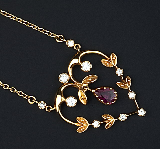 Appraisal: A RUBY AND DIAMOND PENDANT NECKLACE the openwork heart-shaped pendant