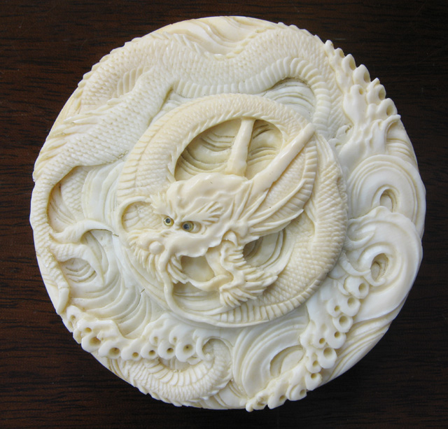 Appraisal: CHINESE HAND CARVED ROUND IVORY COVERED BOX the lid having