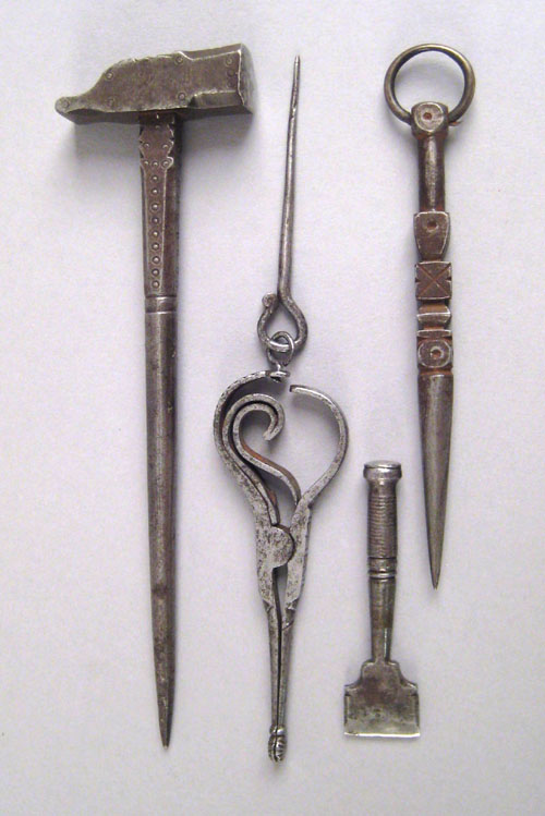 Appraisal: Pennsylvania wrought sewing implements to include a small engraved hammer