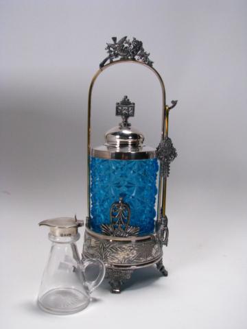 Appraisal: Victorian silverplate pickle castor blue cut glass insert with tongs