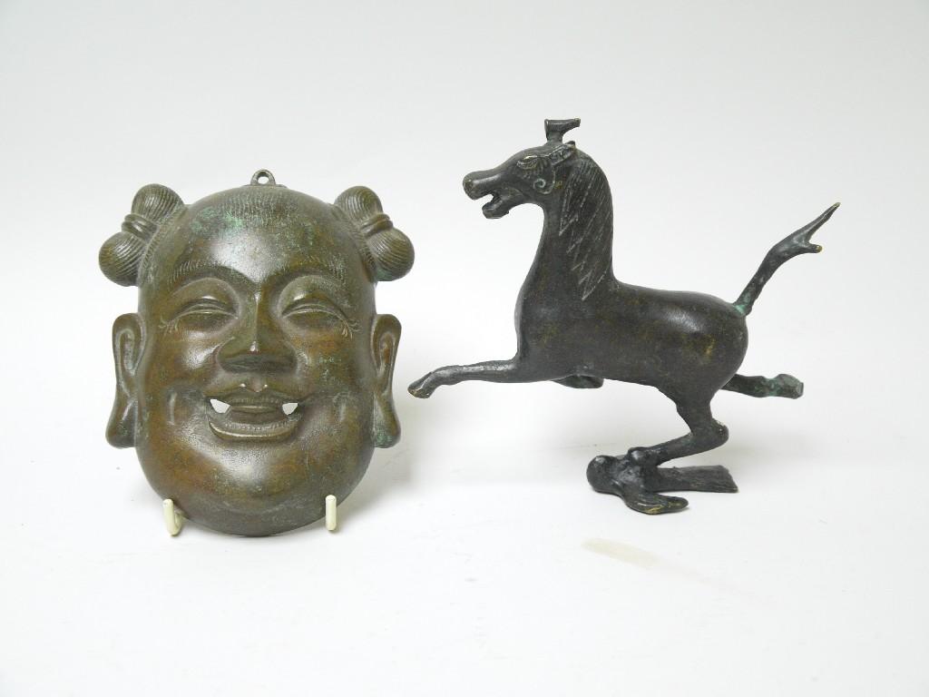 Appraisal: A Chinese bronze Mask in and a bronze Figure of