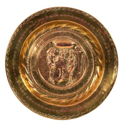 Appraisal: A Nuremberg brass alms dish the centre embossed Adam Eve