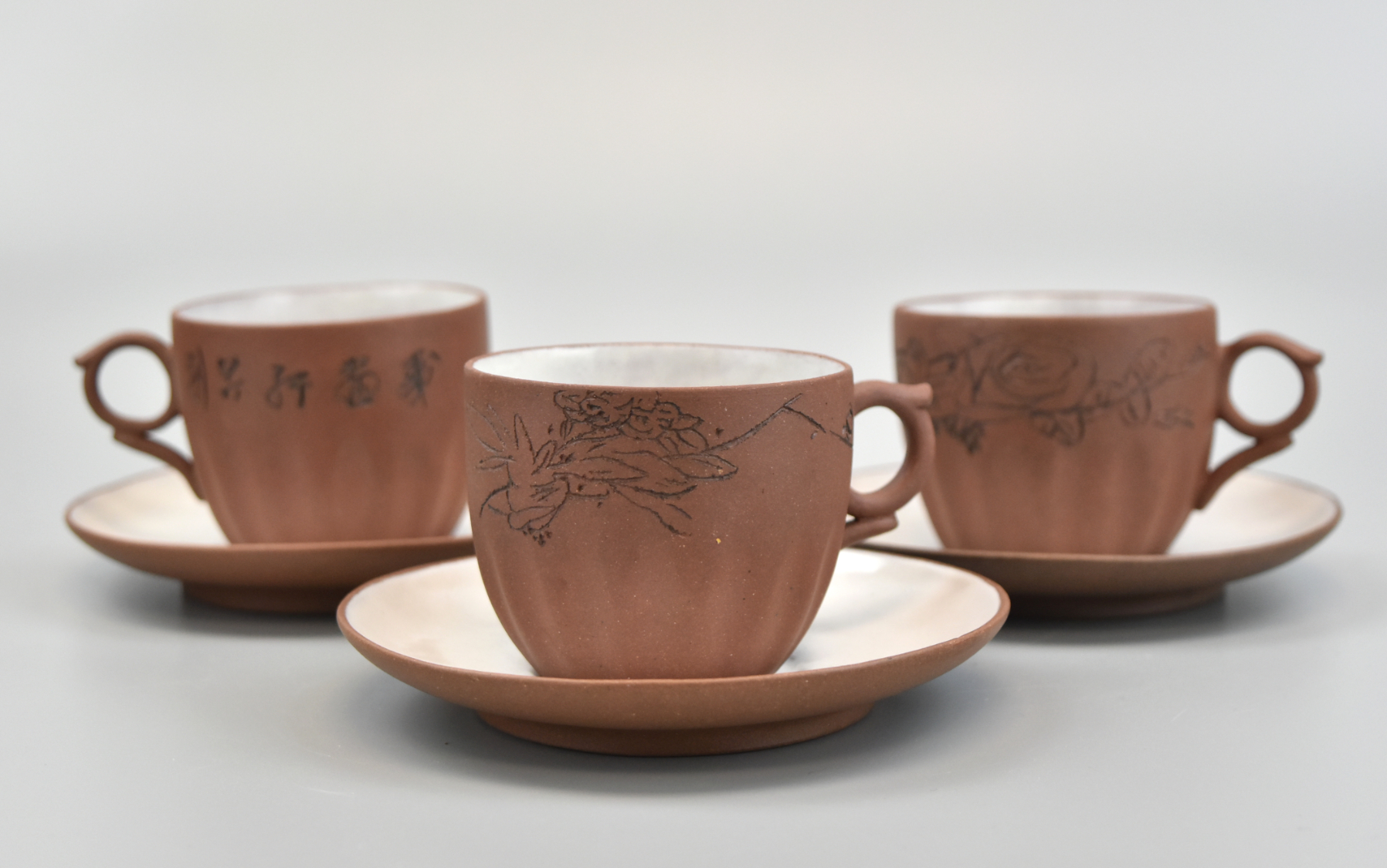 Appraisal: Three set of Chinese Zisha tea cups with glazed interiors