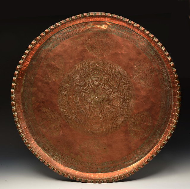 Appraisal: A MIDDLE EASTERN BURNISHED COPPER CIRCULAR TRAY with engraved concentric