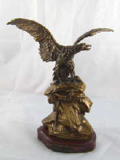 Appraisal: A patinated bronze of an eagle wings outstretched on a