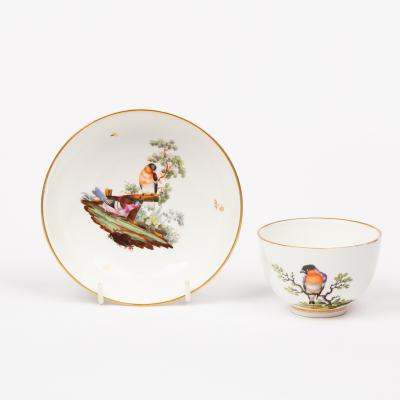 Appraisal: A Hochst teacup and saucer circa decorated a bullfinch perched