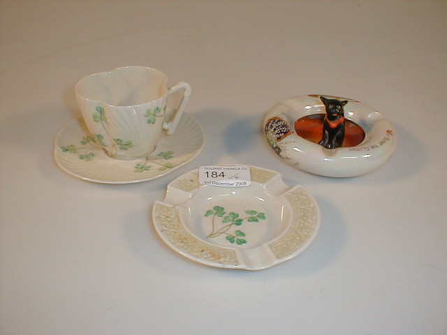 Appraisal: A Belleek shell moulded cup and saucer painted with shamrocks