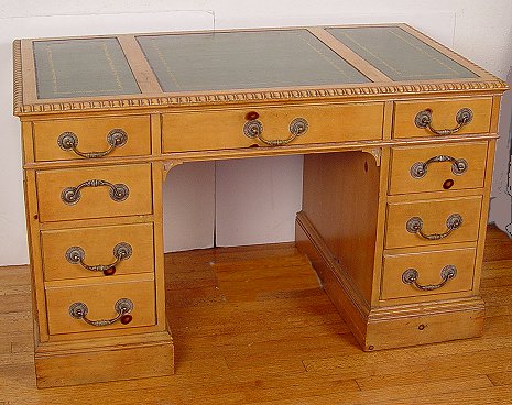 Appraisal: BLONDE MAHOGANY LEATHER TOP KNEEHOLE DESK Green leather top drawers