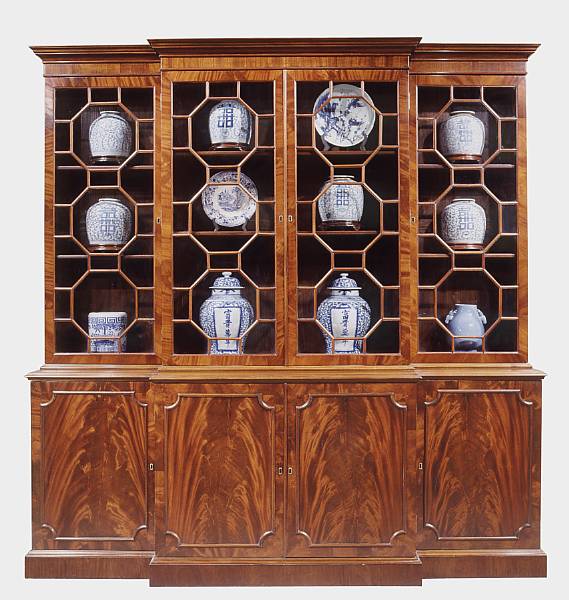 Appraisal: An imposing George III style mahogany breakfront bookcase cabinet The