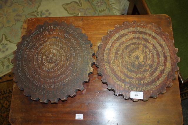 Appraisal: A PAIR OF CARVED STOOL TOPS each engraved with ever-decreasing