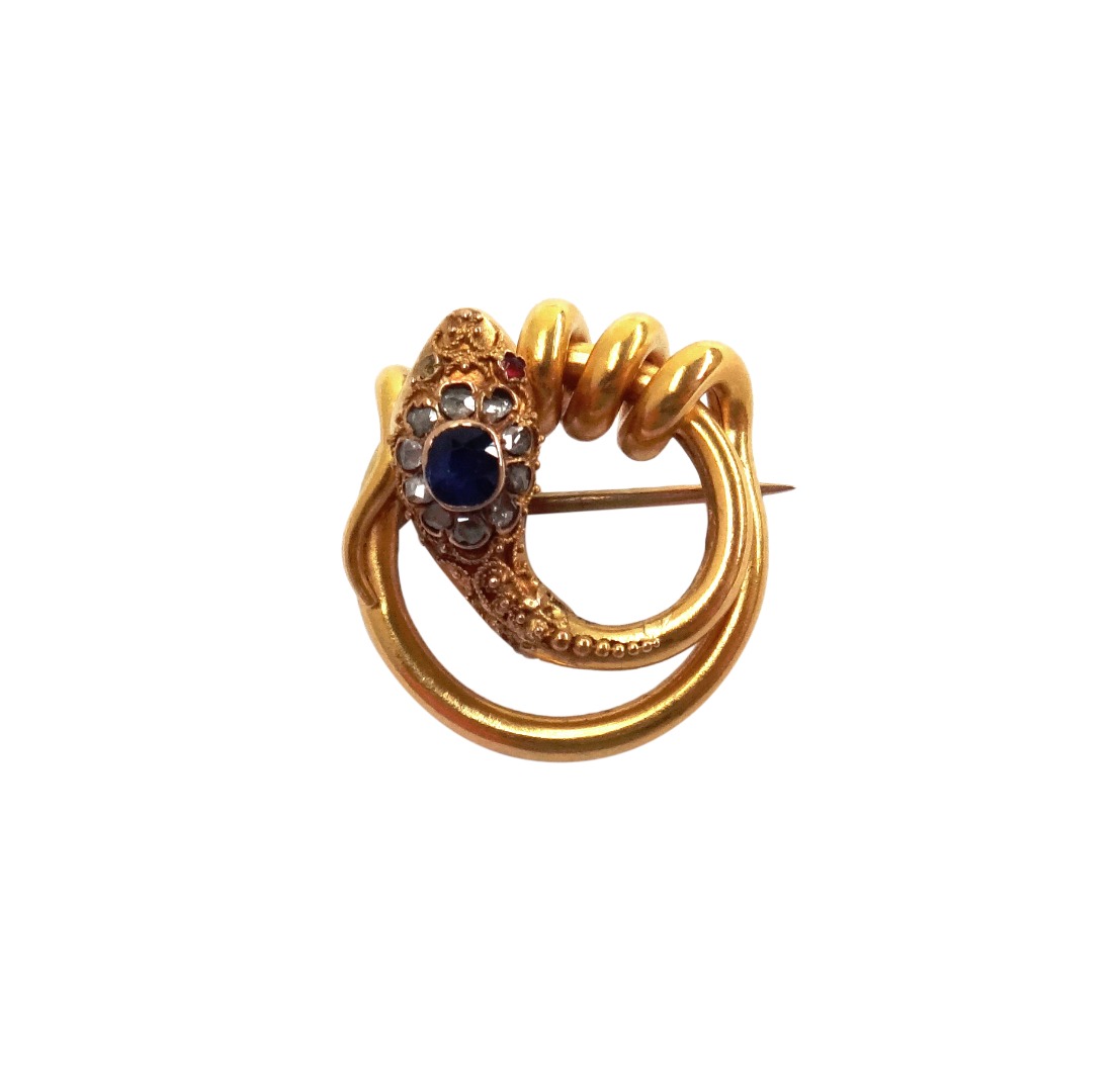 Appraisal: A gold sapphire and diamond set brooch in an entwined