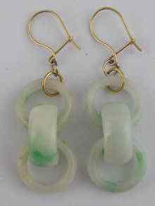 Appraisal: A pair of jade earrings carved as interlocking rings and