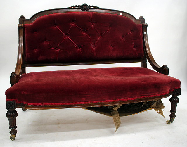 Appraisal: A VICTORIAN MAHOGANY FRAMED SETTEE with button upholstered back and