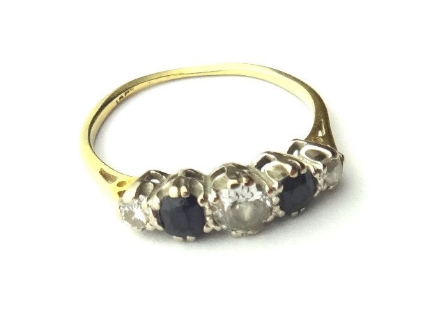 Appraisal: A gold diamond and sapphire set five stone ring mounted