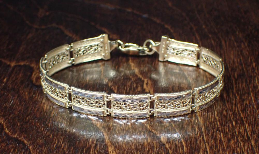 Appraisal: TEN KARAT TWO-TONE GOLD FILIGREE LINK BRACELET The - yellow