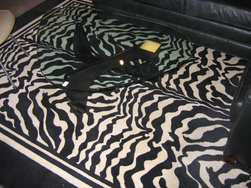 Appraisal: ZEBRA PATTERN ROOM RUG machine woven with a black and