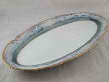 Appraisal: A long oval ceramic fish plater the white centre bordered