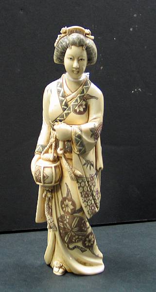 Appraisal: A Japanese style tinted ivory figure of a bijin The