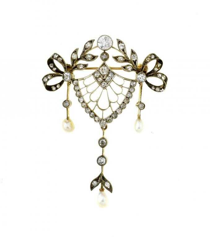 Appraisal: A DIAMOND AND BAROQUE PEARL OPENWORK BROOCH surmounted by a