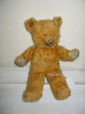 Appraisal: A gold mohair teddy bear with tail red felt open