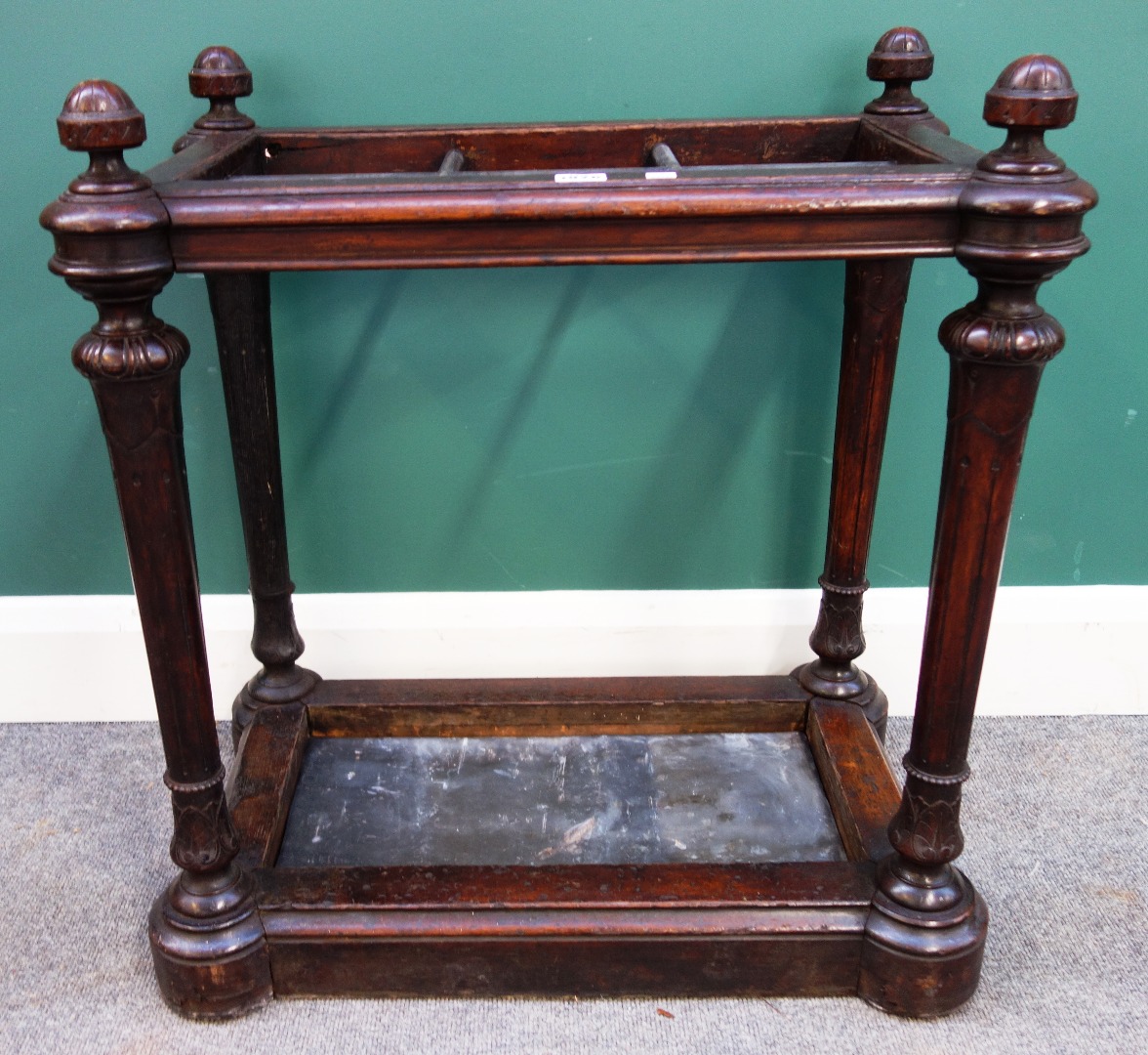 Appraisal: A Victorian oak six division stick stand on tapering fluted