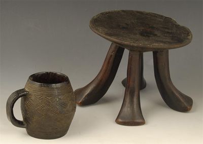 Appraisal: A small Ashanti stool with four scroll legs in cm