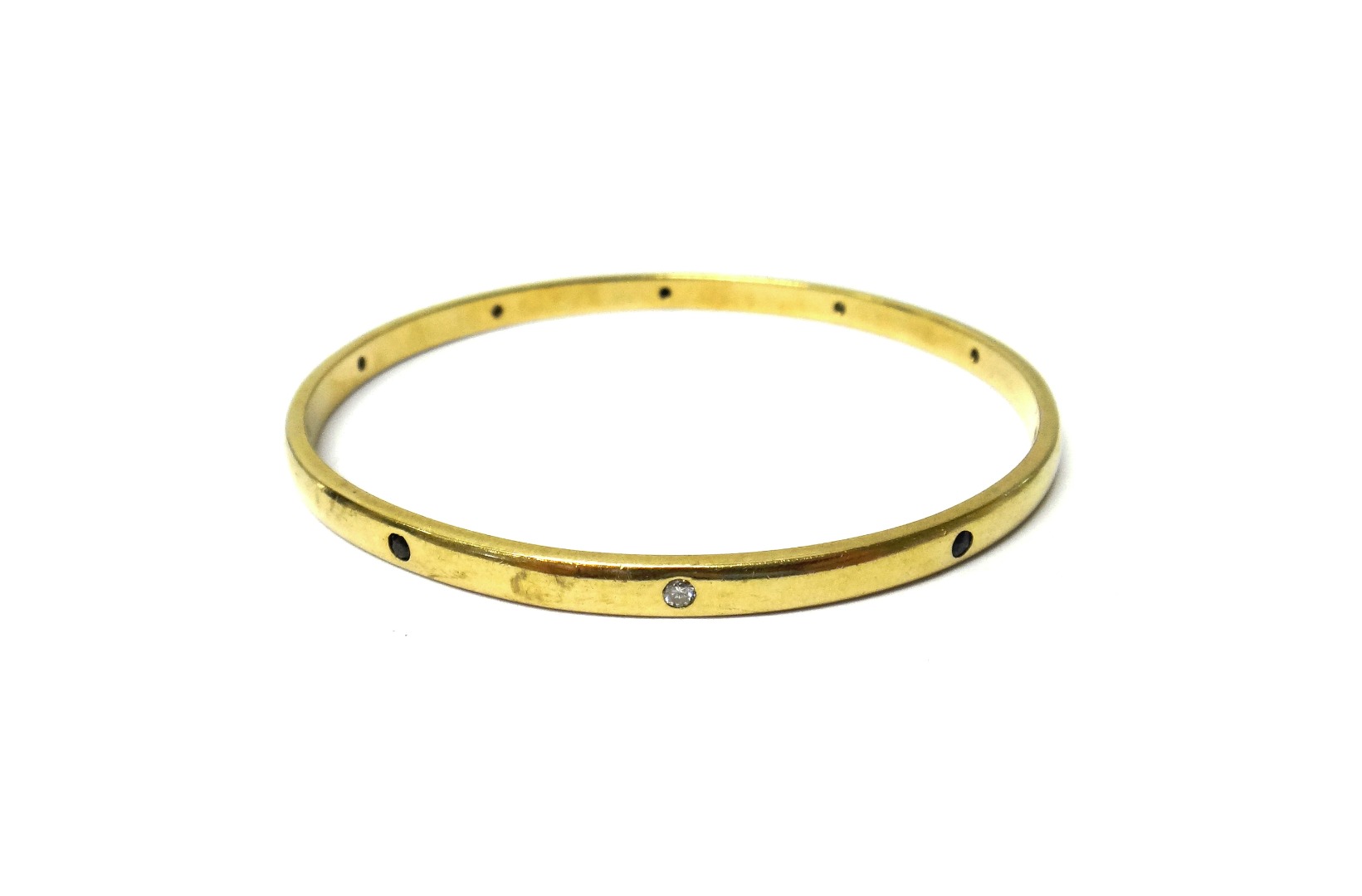 Appraisal: A gold sapphire and diamond set circular bangle mounted with