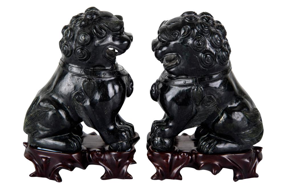 Appraisal: PAIR OF CHINESE CARVED HARDSTONE FOO LIONSeach on a hardwood