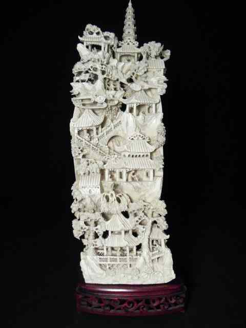 Appraisal: A large intricately carved Chinese ivory landscape mountain in clam