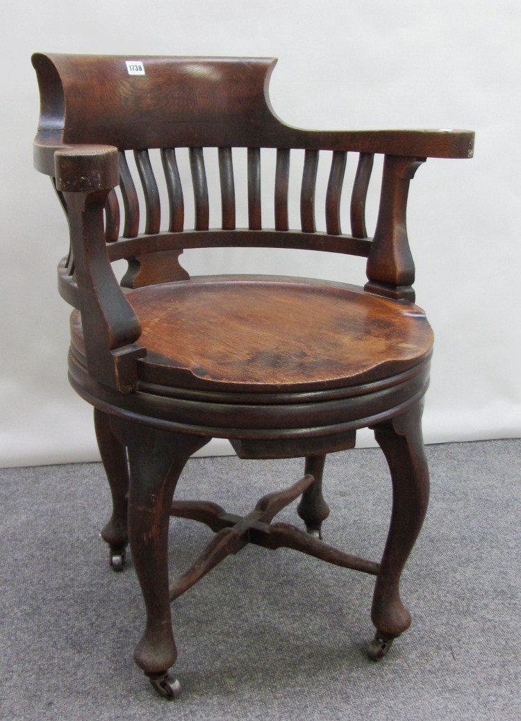 Appraisal: A th century oak office swivel tub back chair on