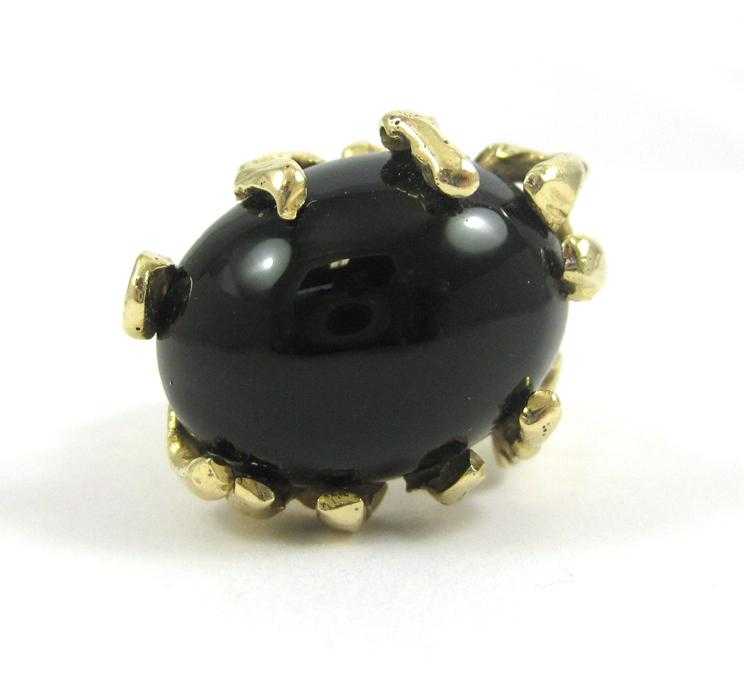 Appraisal: BLACK ONYX AND FOURTEEN KARAT GOLD RING set with a