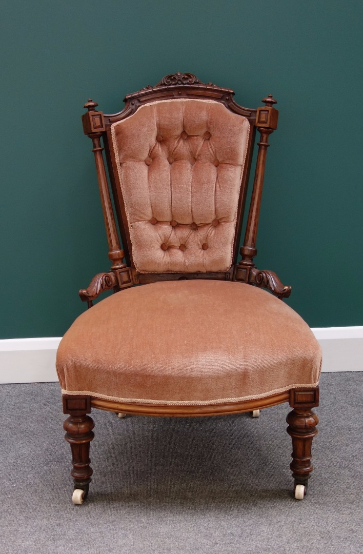 Appraisal: A Victorian walnut framed nursing chair with freestanding fluted columns