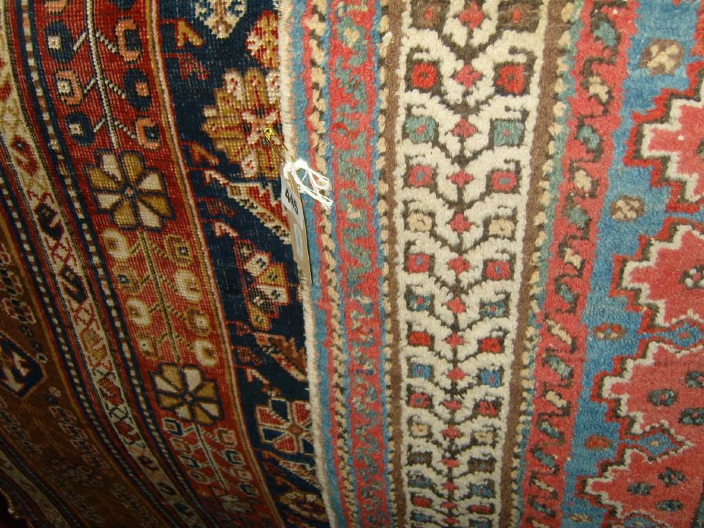 Appraisal: A blue ground Eastern wool carpet with geometric and stylised