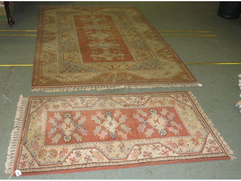 Appraisal: Two Eastern floor rugs on an orange ground