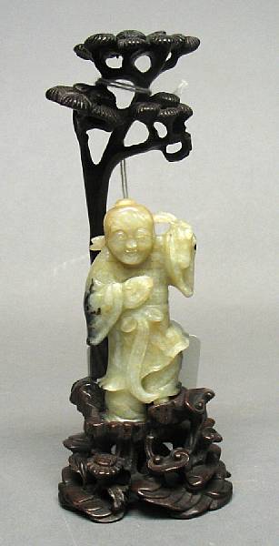 Appraisal: A mottled jade miniature standing figure Possibly depicting an immortal