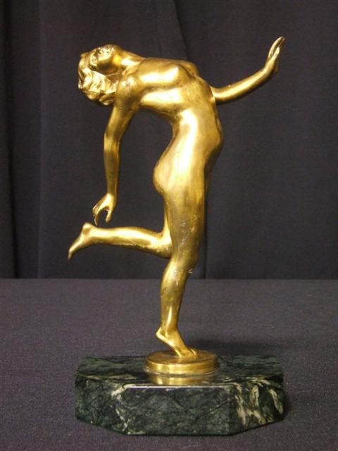 Appraisal: GILT-METAL FIGURE OF DANCING FEMALE NUDE Above a canted green