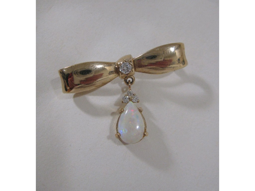 Appraisal: Nine carat gold diamond set bow brooch with suspended pear