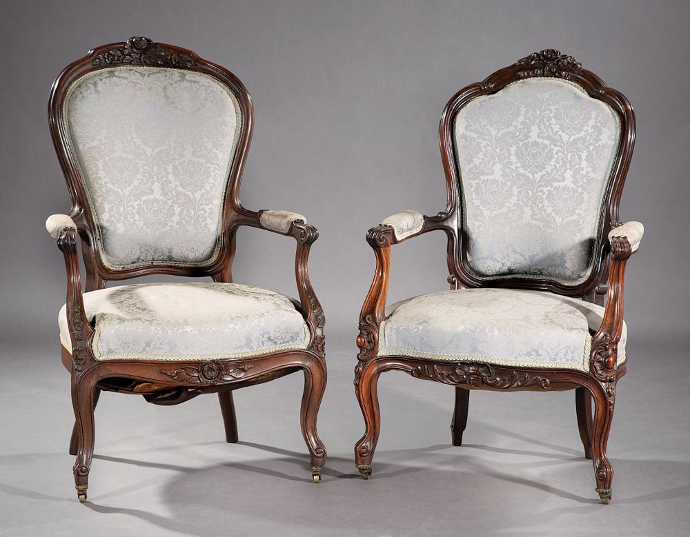 Appraisal: Two Louis XV-Style Carved Walnut Fauteuils with floral crests blue