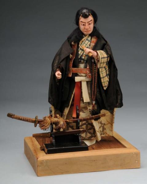 Appraisal: Japanese Ceremonial Doll Description Japan Ca Molded papier-mache character face