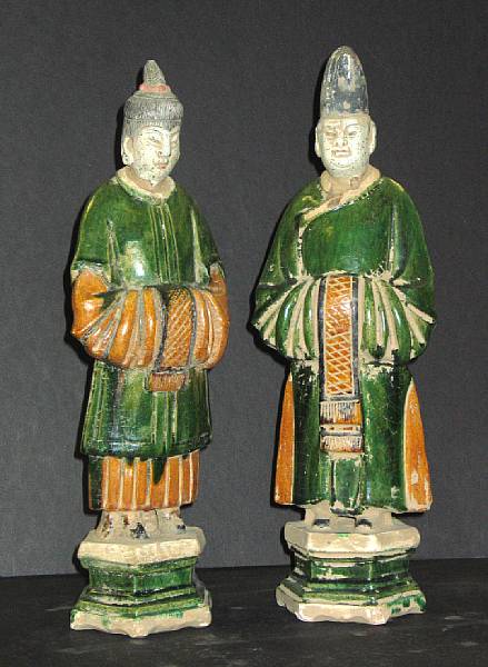 Appraisal: A pair of green and amber glazed pottery tomb figures