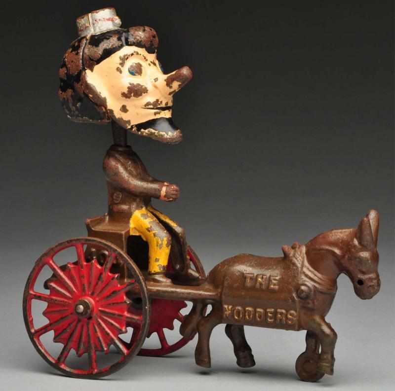 Appraisal: Cast Iron The Nodders Wagon Horse-Drawn Toy Description American Made