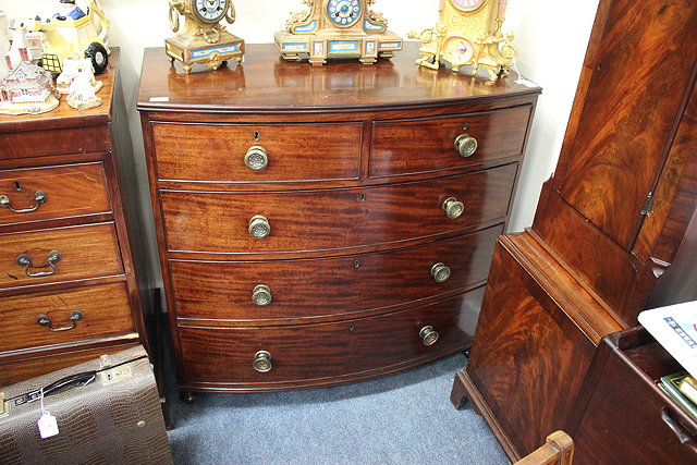 Appraisal: A REGENCY MAHOGANY BOW FRONT CHEST of two short and