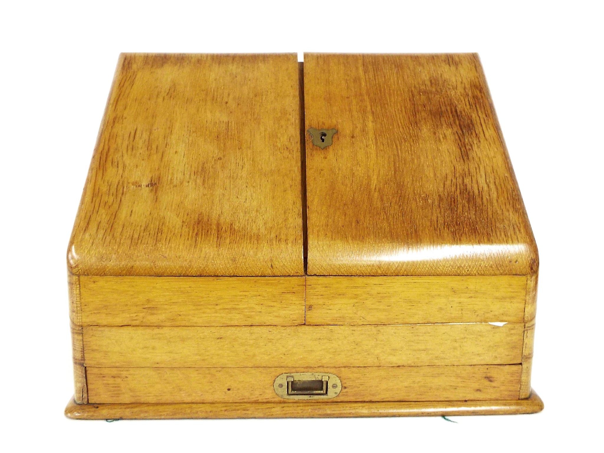 Appraisal: Golden oak stationery box with sloping twin doors enclosing a