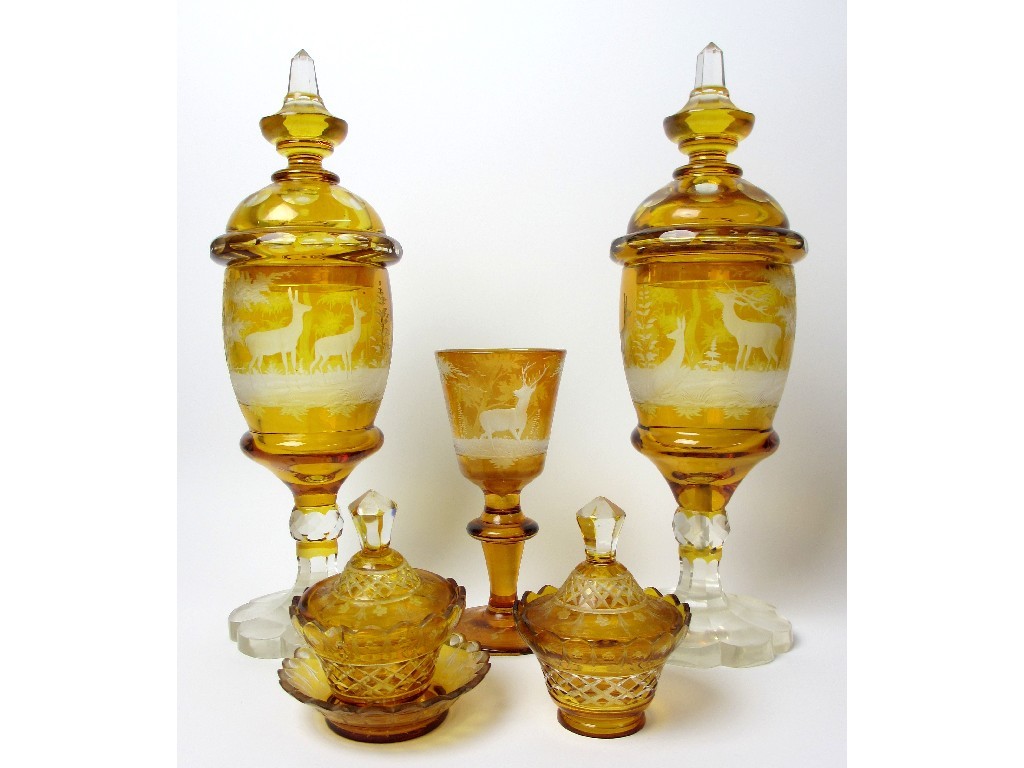 Appraisal: A pair of Bohemian amber and engraved glass covered vases