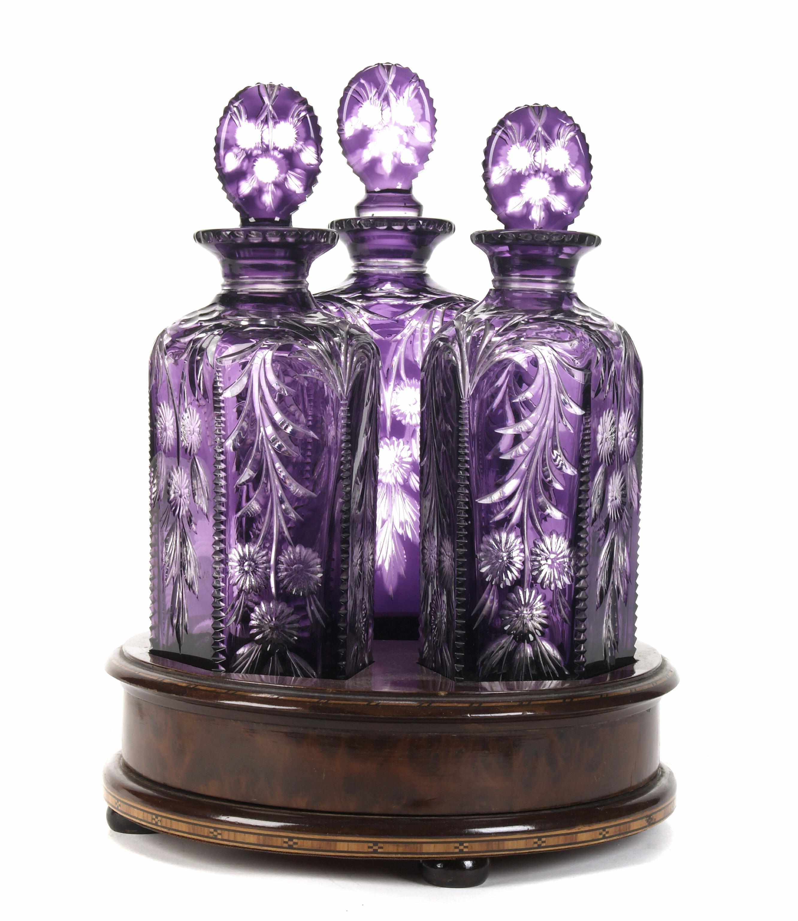 Appraisal: A set of three amethyst cut glass decanters and stoppers