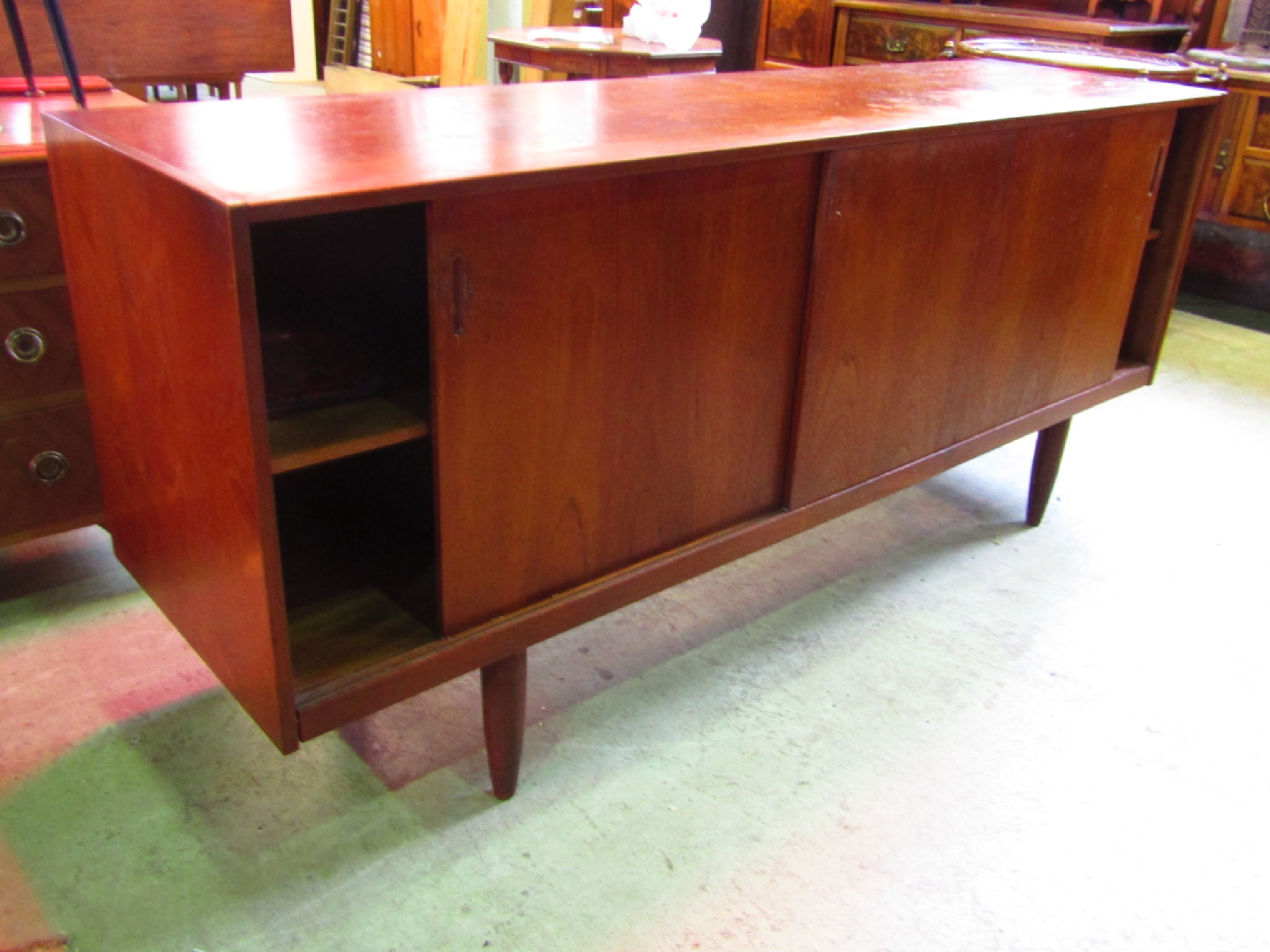 Appraisal: A mid th century teak long and low sideboard enclosed