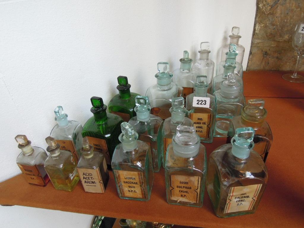 Appraisal: A collection of chemist bottles and jars including two green