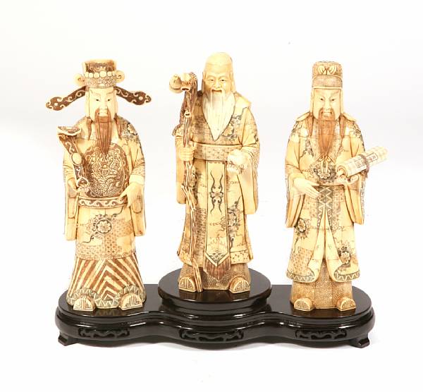 Appraisal: A set of three Chinese carved bone veneer figures on