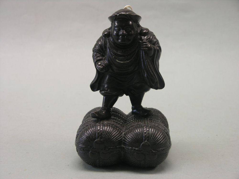 Appraisal: A Japanese bronze figure Meiji period comical squat male walking